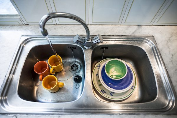 Dirty dishes in the sink driving up kitchen humidity